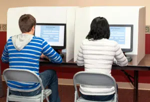 Students in computer lab using privacy shields